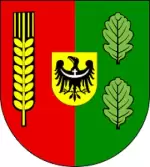 Herb Miękini: tarcza dzielona w słup — po prawej zielone pole z dwoma liśćmi dębu, po lewej purpurowe pole ze złotym kłosem zboża; w centrum złote pole sercowe z czarnym orłem dolnośląskim ze srebrną przepaską na piersi.